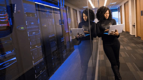 Professional woman standing in a server room